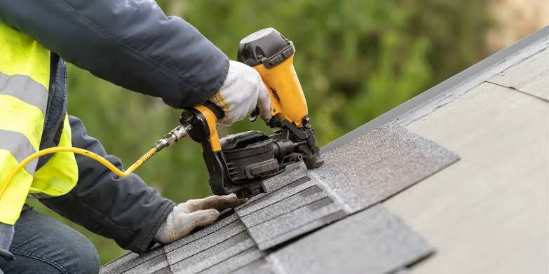 Placeholder for Randy's job photo: close view of a nail gun on a shingle course