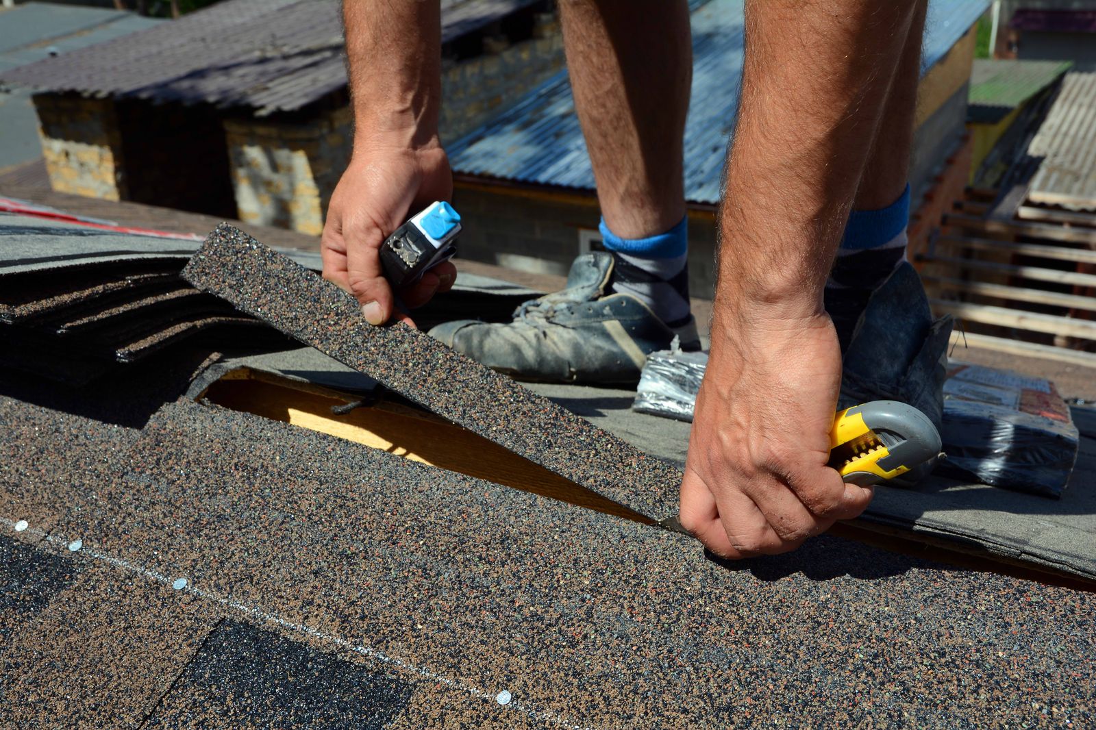 Placeholder for Randy's job photo: cutting a shingle to fit at the edge of a roof
